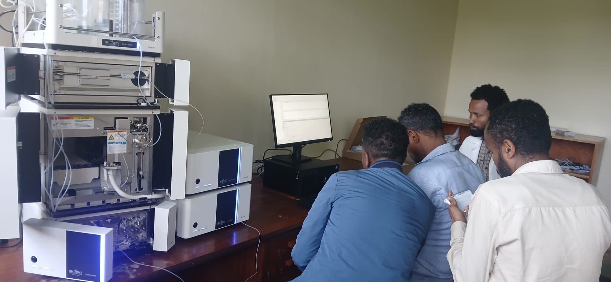 Laboratory staff working through the HPLC software alongside the installed system