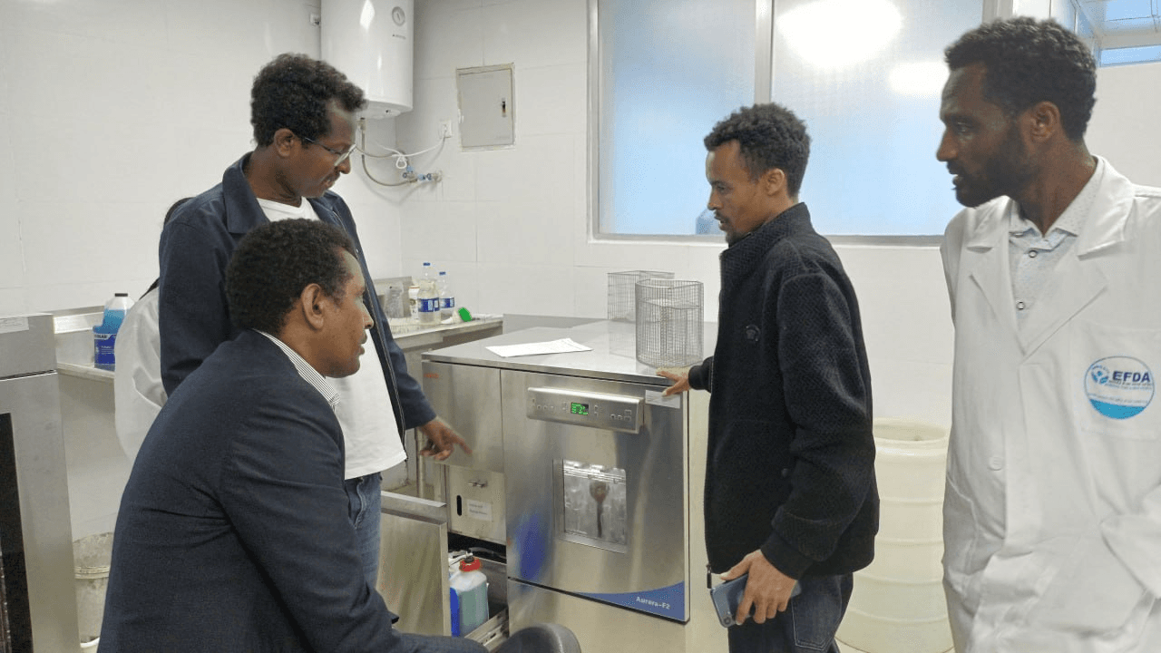 Ethiolab engineer walking EFDA staff through the installed glassware washer